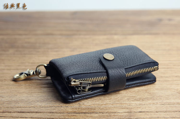 Black textured leather key chain wallet for men with gold-toned zipper and metal clasp.