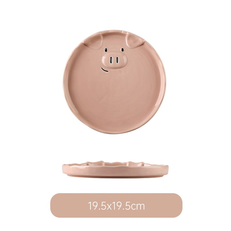 A blush pink ceramic pig-shaped plate with molded ears eyes and snout from the cute pig ceramic dinnerware set.
