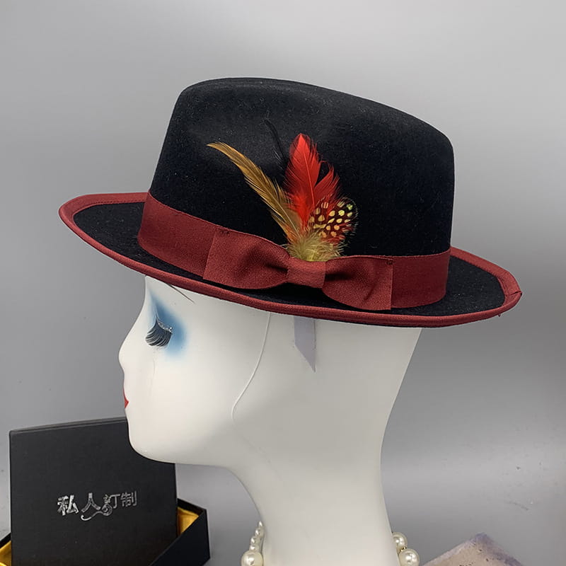 Unisex woolen felt fedora hat in black with a burgundy ribbon bow and decorative red and gold feather accent.