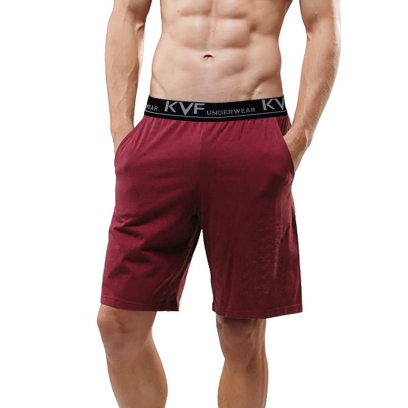 Men cotton boxer shorts in maroon with a black elastic waistband featuring white lettering designed for loose casual lounge gym jogging use