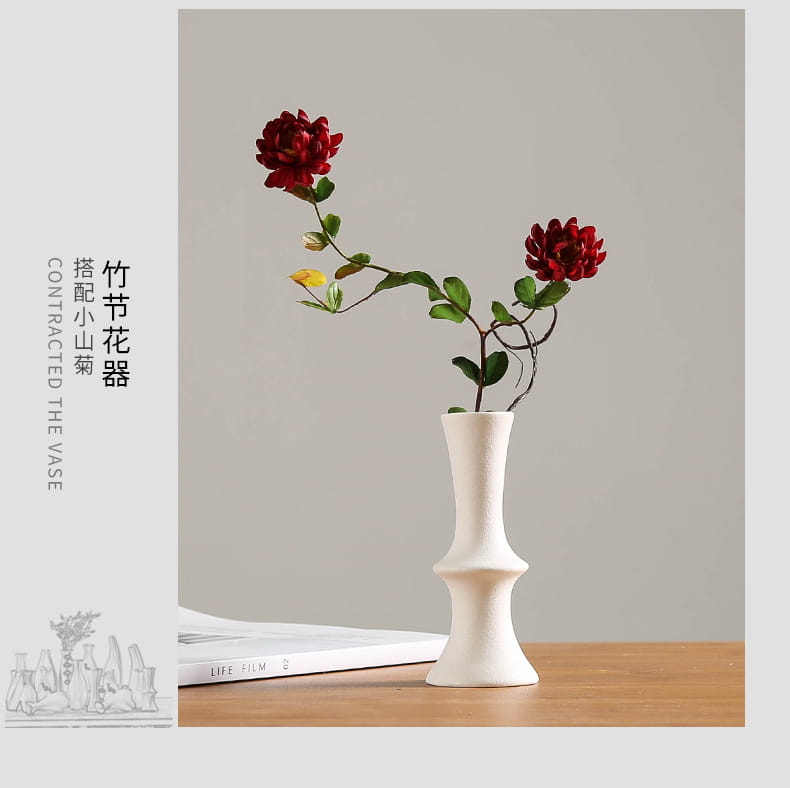 modern white ceramic vase with slender sculpted form and flared base for floral decor
