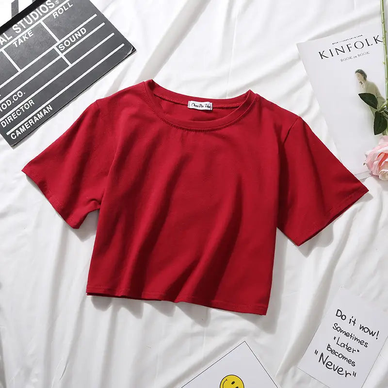 A vibrant red women solid short sleeve crop top casual t-shirt made from soft fabric featuring a simple round neckline.