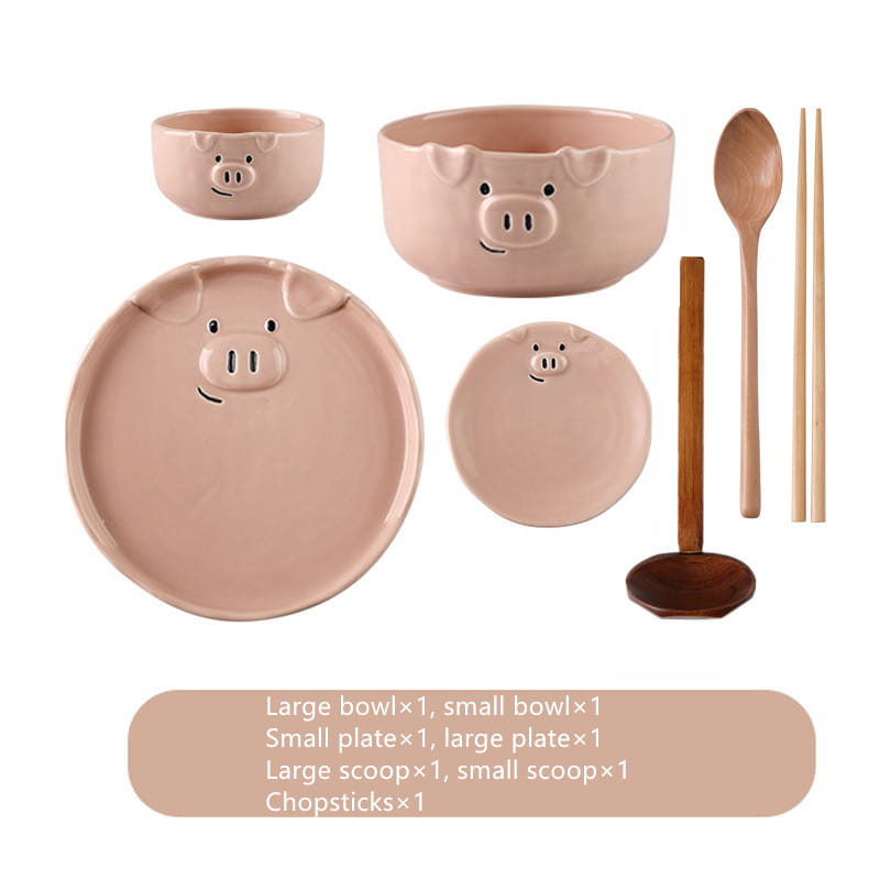 Cute pig ceramic dinnerware set featuring pastel pink pig-themed ceramic plates, large and small bowls, and wooden utensils for dining.