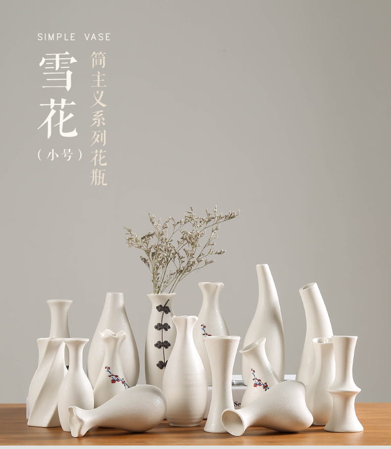 a collection of modern white ceramic vases featuring minimalist designs with delicate black floral motifs and abstract sculptural forms for floral decor