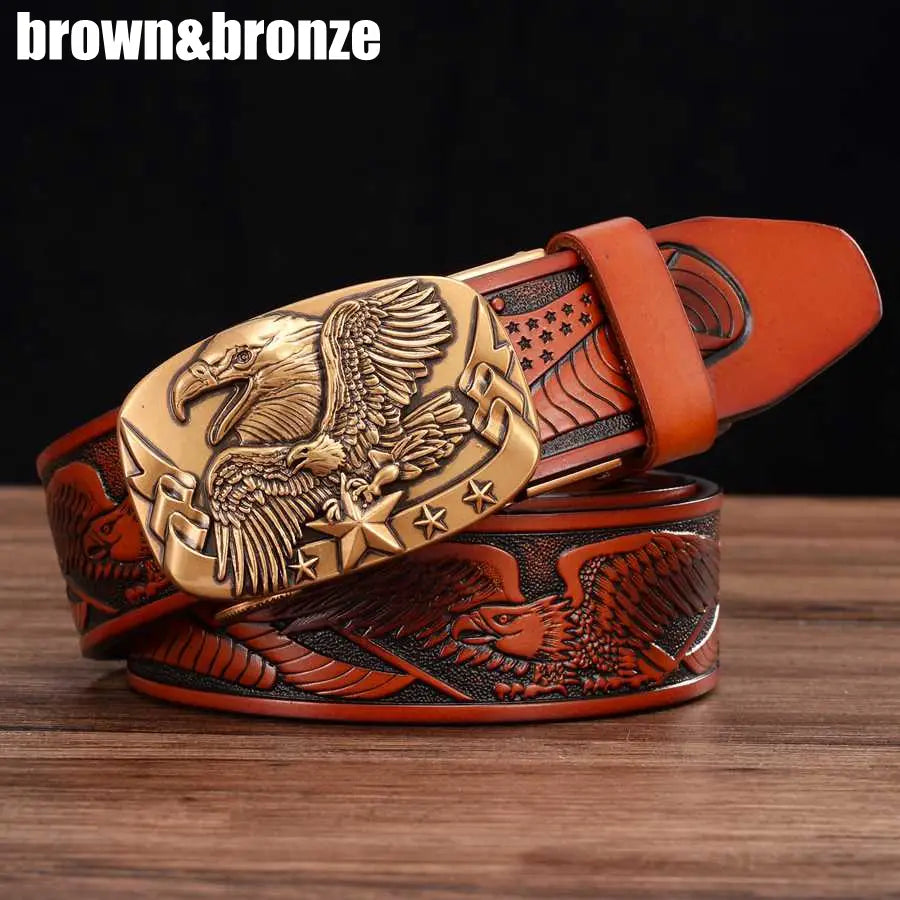 A rich brown men’s leather ratchet belt with an intricately engraved bronze eagle buckle featuring stars and wings and embossed American flag motifs along the strap.