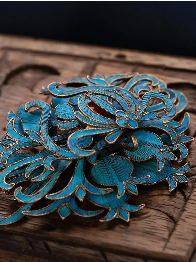 Filigree brooch turquoise floral palace jewelry featuring delicate turquoise enamel with intricate gold-toned metalwork and a central red accent.