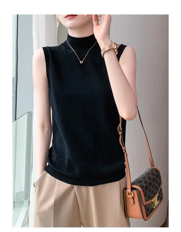 Black sleeveless wool turtleneck sweater vest with a soft smooth texture and elegant design.