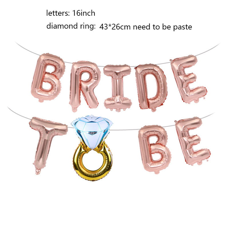 Rose gold foil balloon banner set spelling bride to be with a central diamond ring-shaped balloon featuring a blue gemstone and golden band for bridal celebrations.