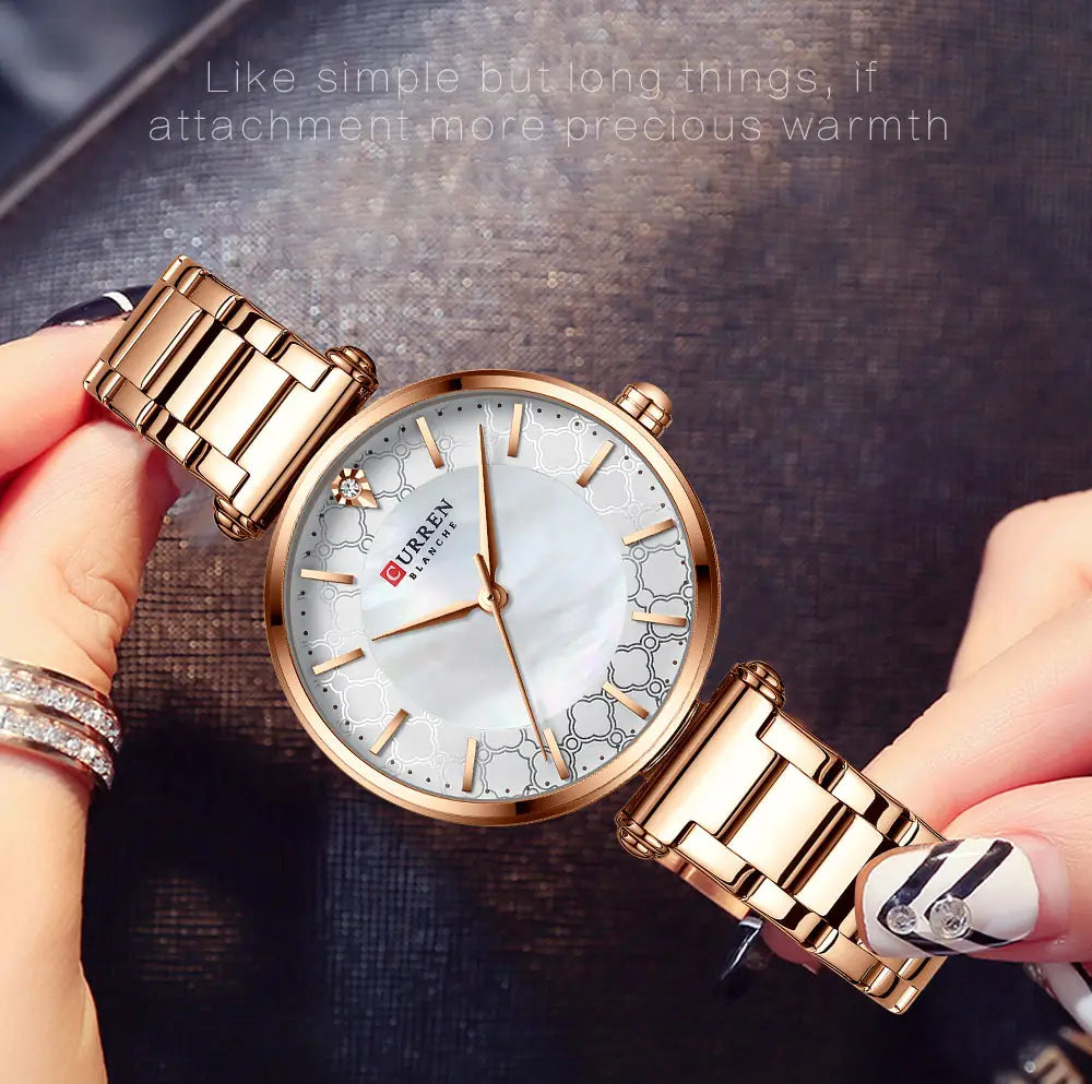 Rose gold-toned metal bracelet Curren women luxury thin quartz watch with a white mother-of-pearl dial featuring subtle geometric patterns and diamond accents at the 12 o’clock position.