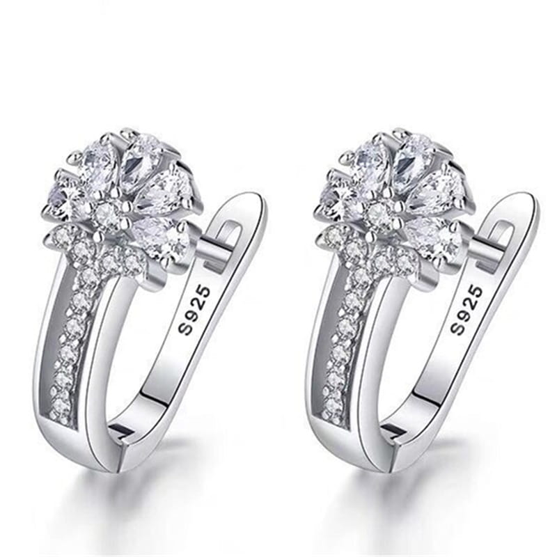 Sterling silver flower hoop earrings with clear cubic zirconia stones set in a delicate pave-style design.