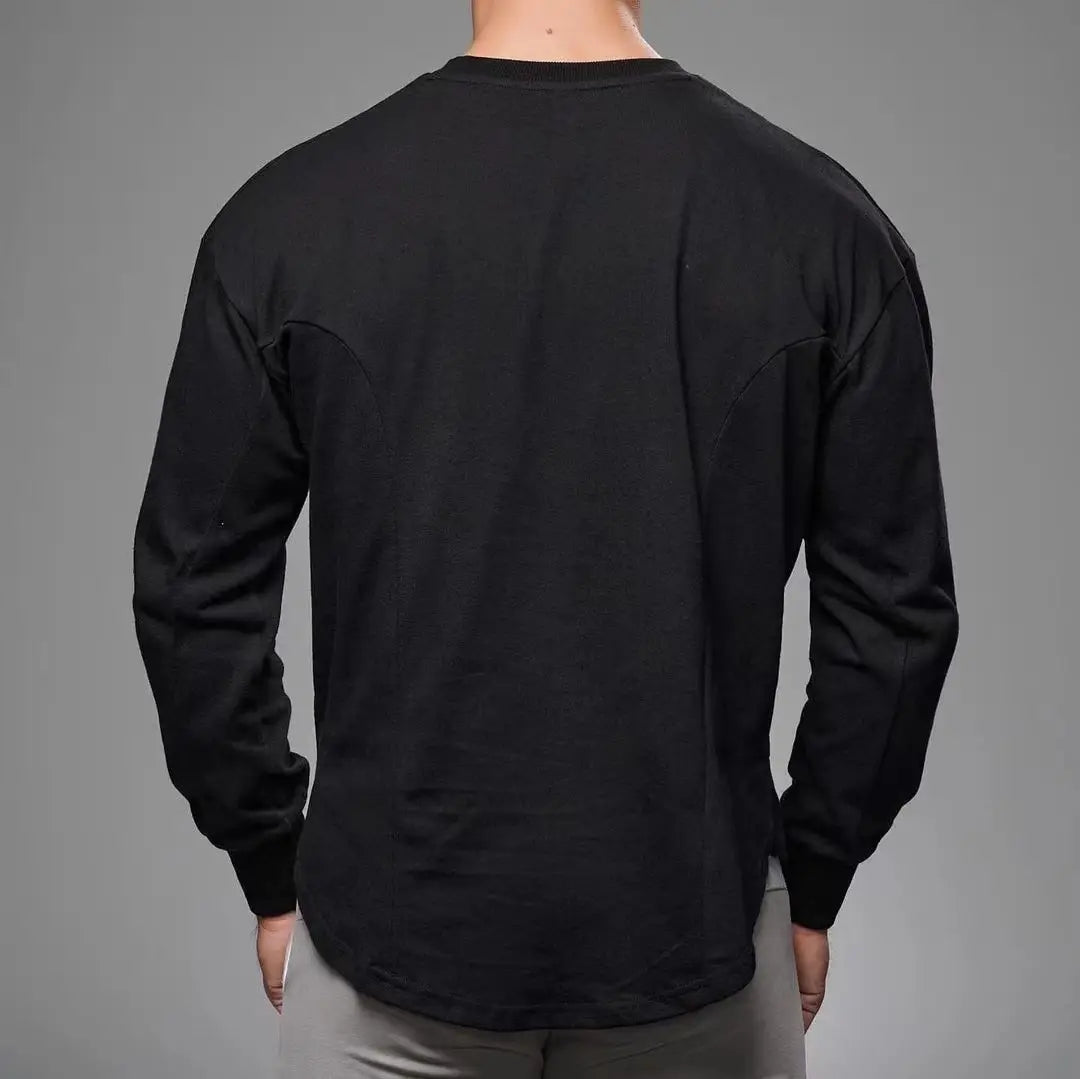 Men long sleeve cotton t shirt in black with a relaxed fit crew neck and subtle seam detailing featuring a curved hem.