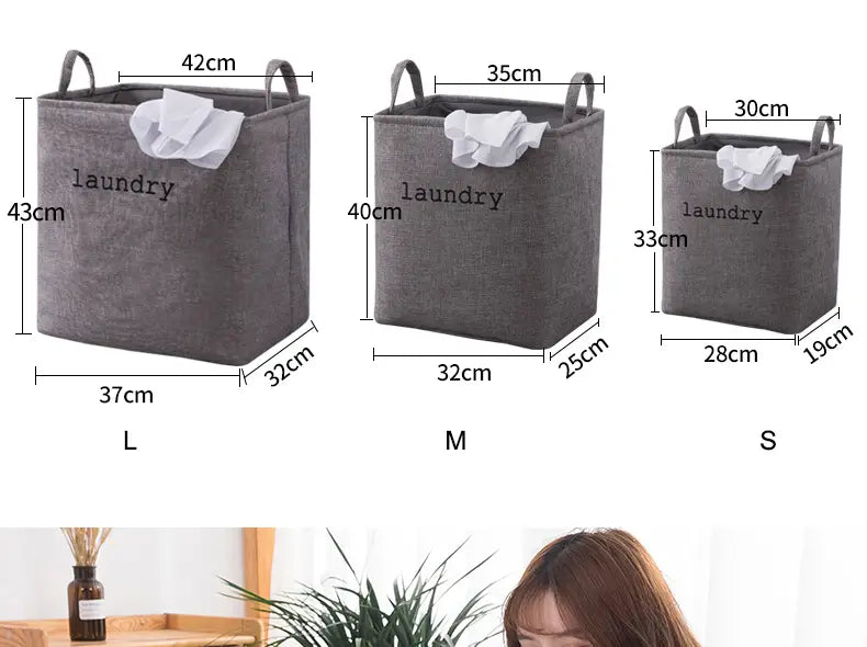 gray fabric foldable laundry basket with handles and laundry printed on the front available in three sizes l m and s for use as storage baskets and foldable storage baskets