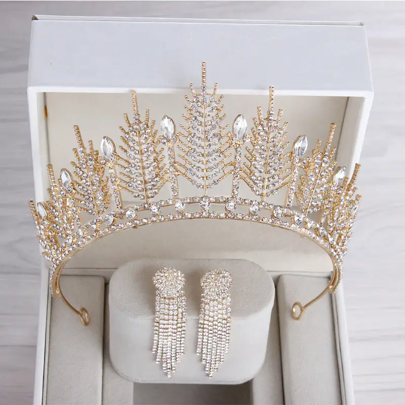Gold-colored crystal bridal tiara adorned with intricate leaf-like designs and sparkling clear crystals for wedding crown headpiece.