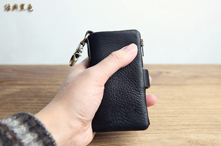 Black textured leather key chain wallet for men with brass hardware shown from the back side