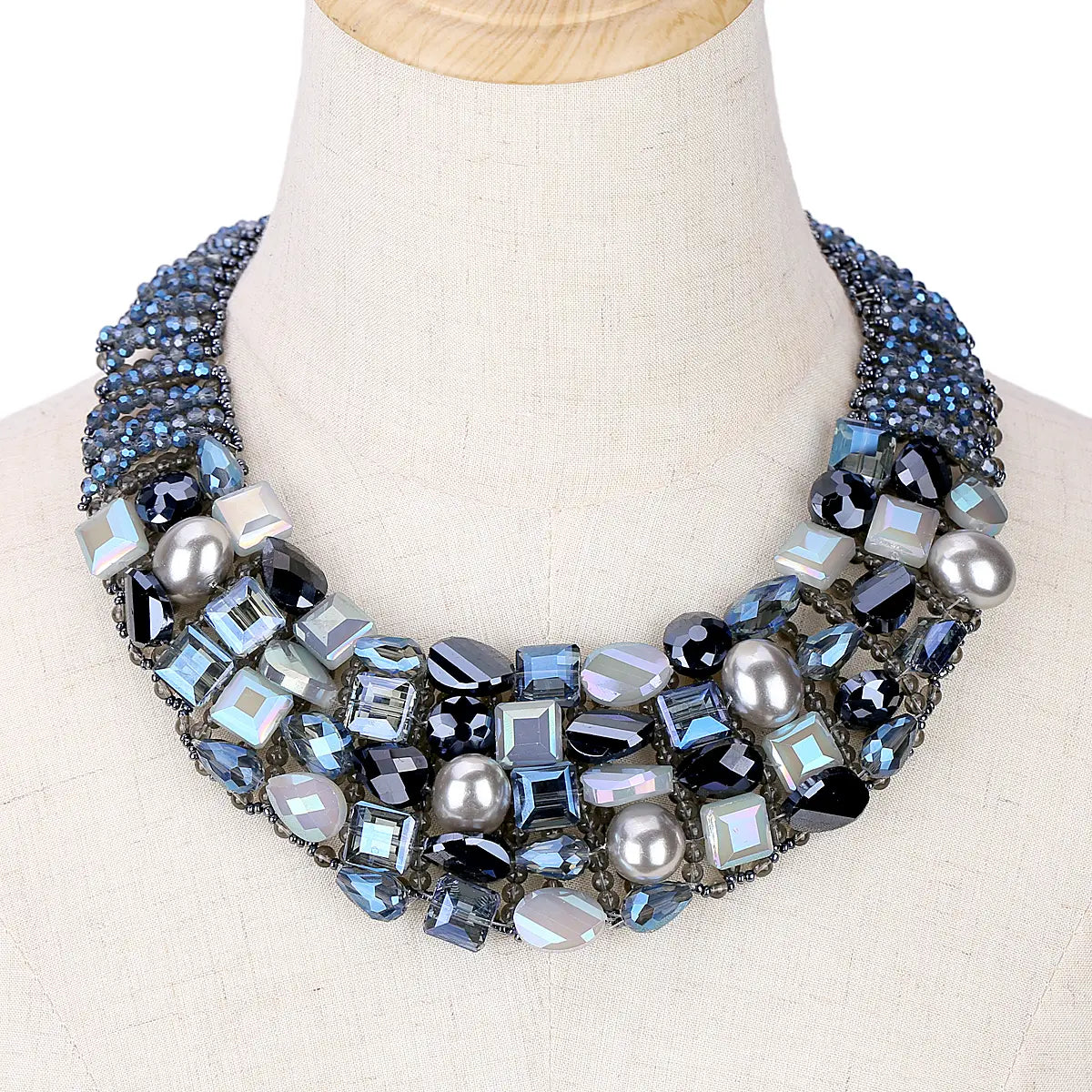 A multi-layered crystal pearl statement choker necklace featuring blue black and silver-toned crystals and pearls set in a dark metal framework.