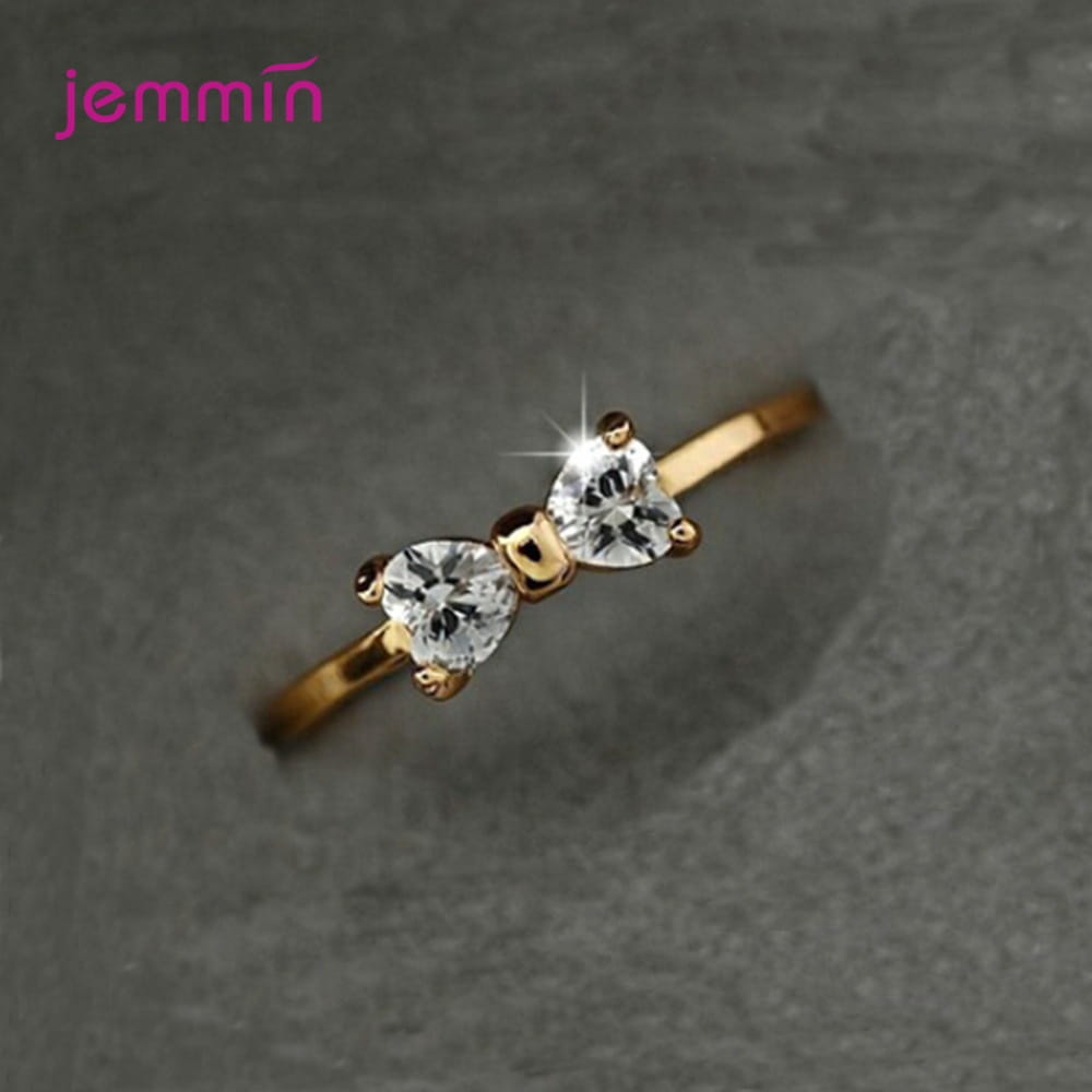 Bague de mariage en nœud en argent sterling en oxyde de zirconium cubique, surmontée d’une bague ton or, présentant deux pierres claires en forme de cœur étincelantes dans un design délicat de nœud.