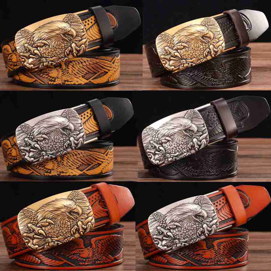 Men’s leather ratchet belts featuring handcrafted leather straps with intricately carved eagle buckles in gold silver and bronze finishes with detailed feather patterns.
