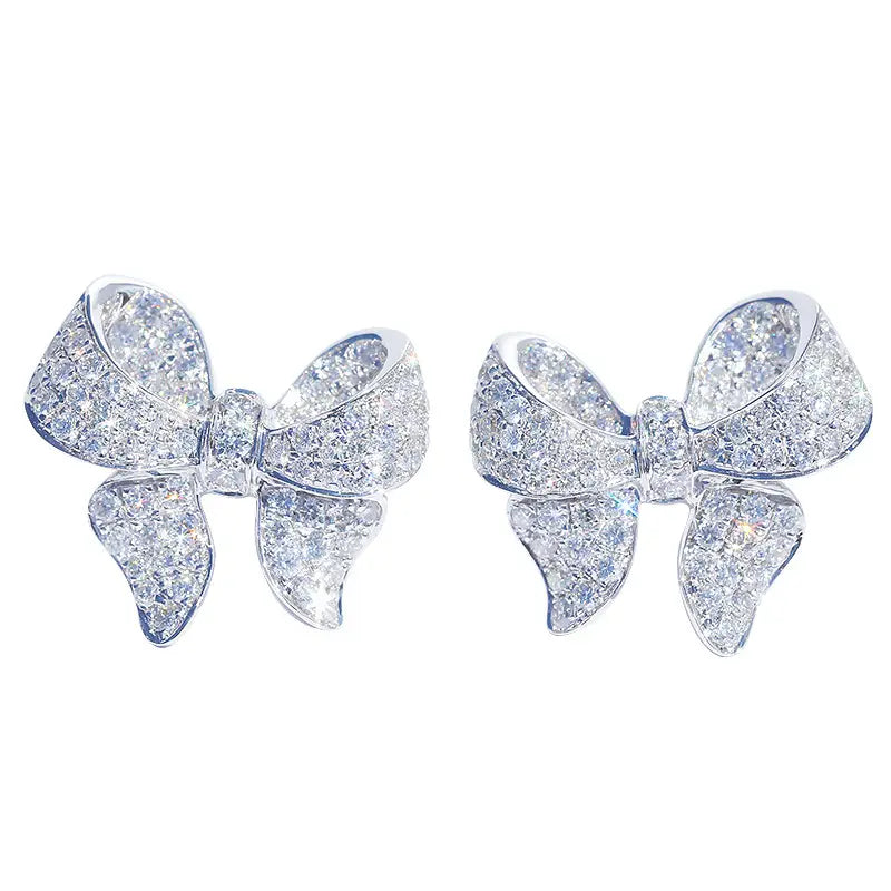 Sparkling diamond-encrusted bow-shaped earrings in a sleek silver setting from the silver bowknot zircon necklace and earrings set.