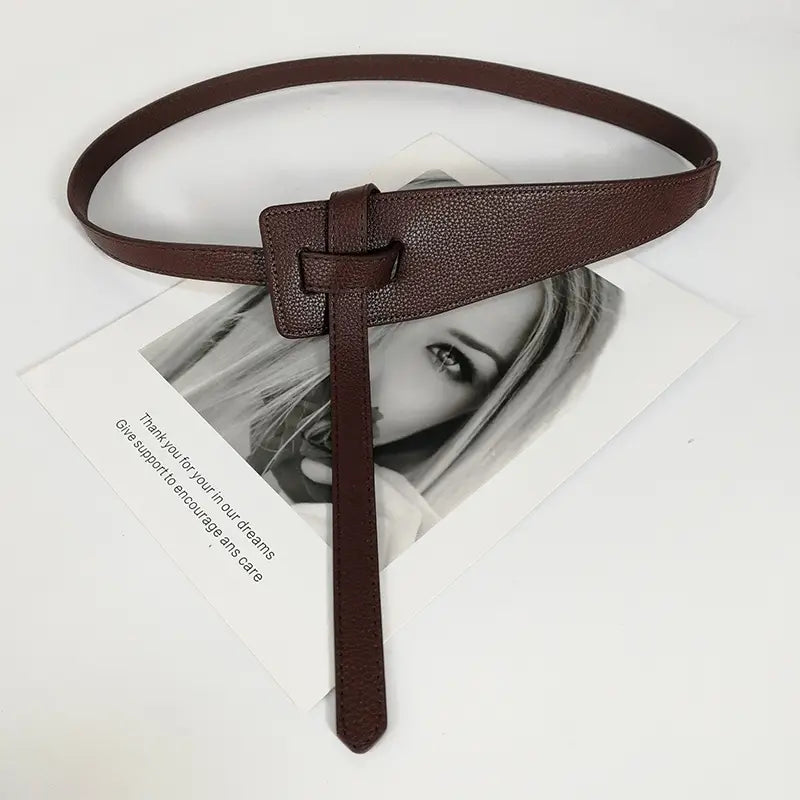 Brown leather women’s wide pu leather knot waist belt with a textured surface and rectangular buckle.