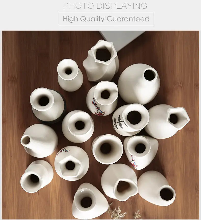 A collection of modern white ceramic vases featuring varying shapes and delicate floral designs ideal for floral decor.