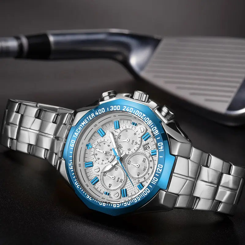Gold chronograph watch for men featuring a silver-toned stainless steel case with a vibrant blue bezel and matching accent details on the dial with a stainless steel link bracelet.