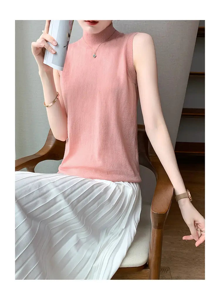 Soft pink wool turtleneck sleeveless sweater vest with a high neckline and ribbed trim.