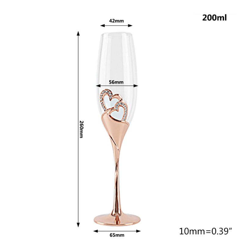 Wedding champagne flutes gold heart toasting glasses set featuring rose gold flutes with twisted stems and interlocking heart charms adorned with clear rhinestones near the base.
