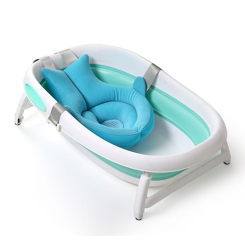 A turquoise and white foldable newborn bath mat and cushion featuring a matching plush dolphin-shaped bath pillow for infant comfort during bath time.