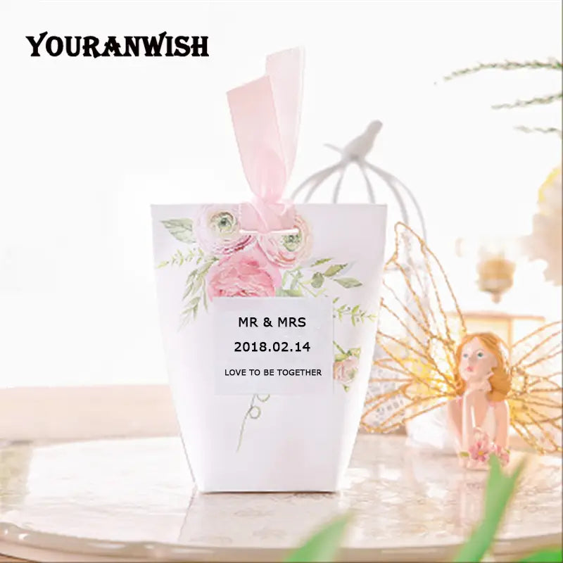 Boîte de faveur de mariage en papier blanc avec design floral rose et nœud de ruban rose assorti, provenant du lot de boîtes de faveur de mariage en papier floral rose de 50.