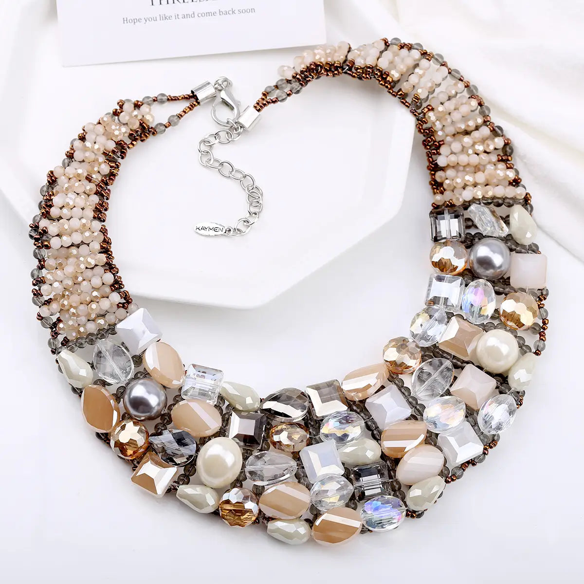 Crystal pearl statement choker necklace featuring a multi-strand design with clear frosted and metallic beads in beige gold silver and brown tones.