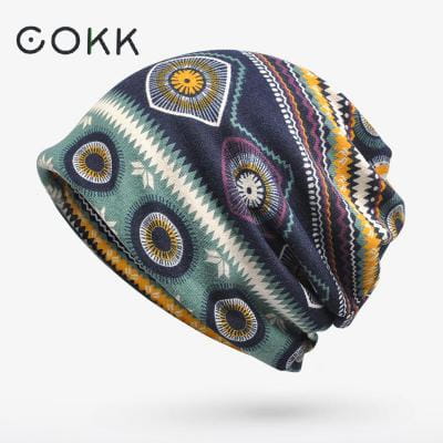 Cokk brand floral knit beanie hat unisex casual autumn headwear with a vibrant patterned design featuring geometric shapes and circular motifs in teal navy blue yellow purple and white.