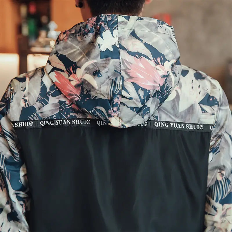 Mens hooded jacket asia size featuring a vibrant tropical print lightweight windbreaker with a black lower panel and branded trim.