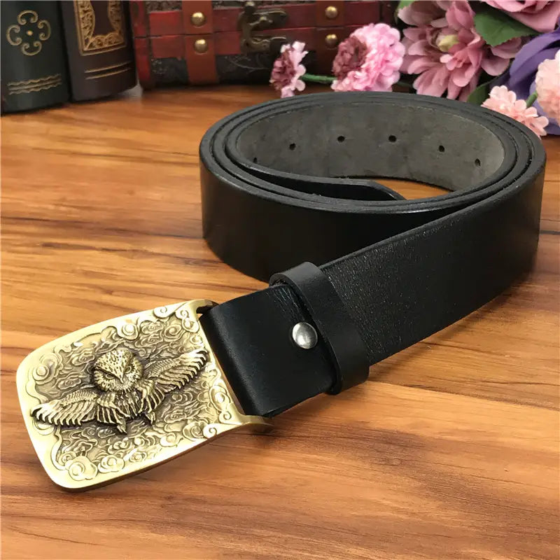 Black leather belt with an ornate gold-toned brass owl belt buckle featuring a detailed carved owl design for men jeans.
