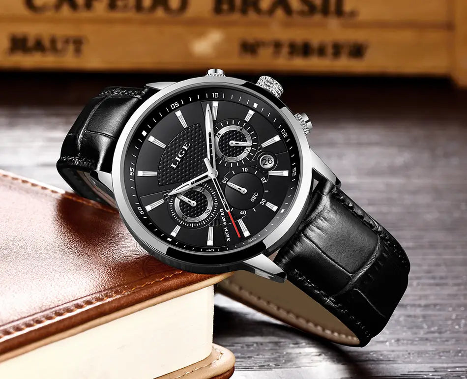 Lige men’s leather chronograph quartz watch featuring a black leather strap, silver-toned case, and black dial with white markings, red second hand, and three subdials.