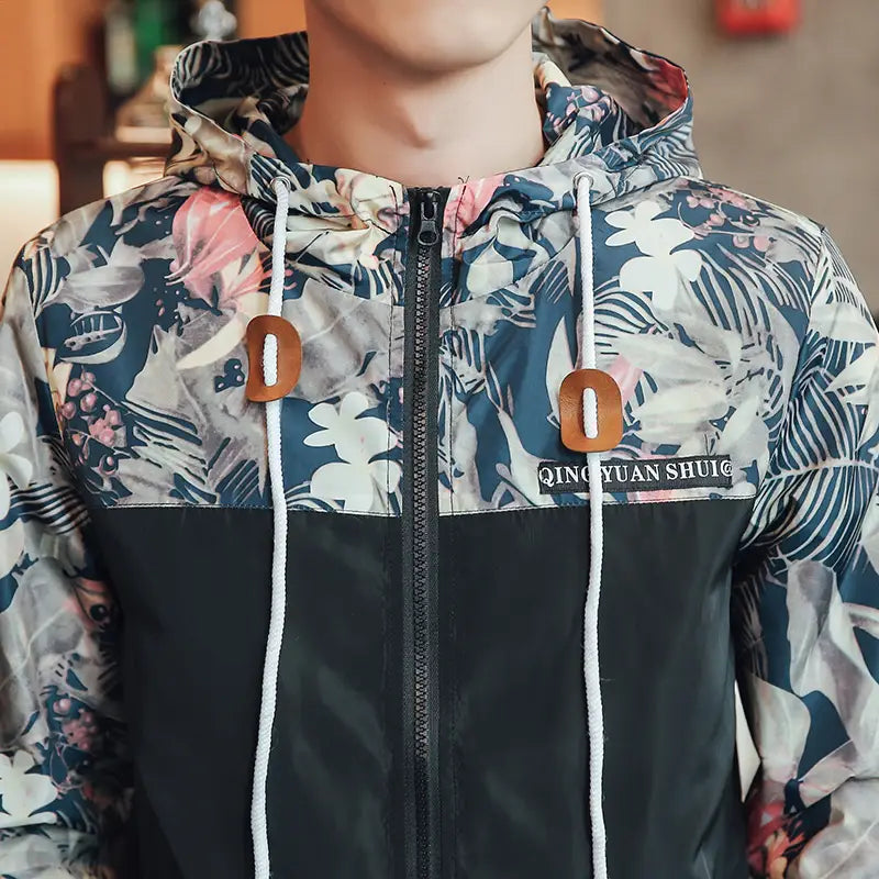 Mens hooded jacket floral lightweight windbreaker in asia size featuring a vibrant navy blue white and pink floral pattern with contrasting black panels on the lower torso and brown leather toggle pulls.