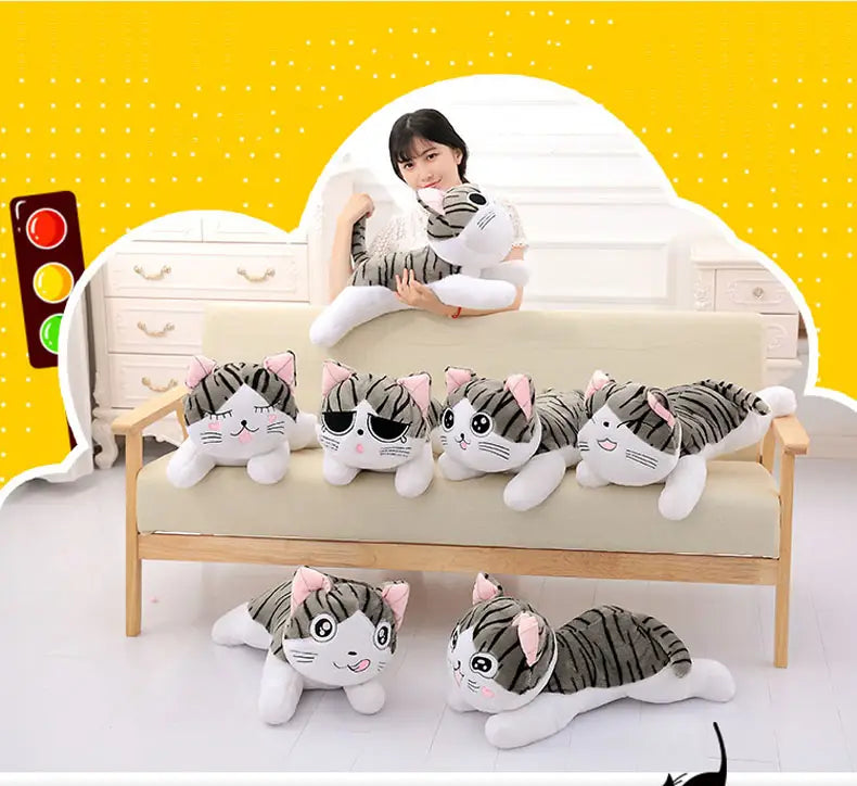 plush gray and white striped cheese cat soft animal doll with pink inner ears made of soft animal fabric.