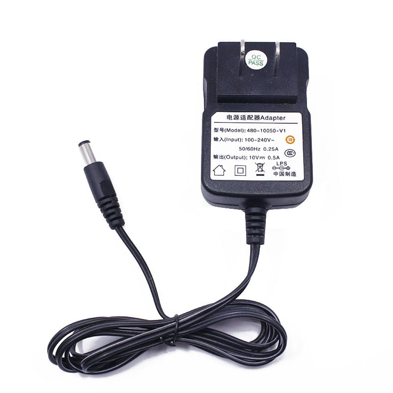 black plastic baofeng uv-5r battery charger ac adapter with a coiled black power cord and a cylindrical metal plug