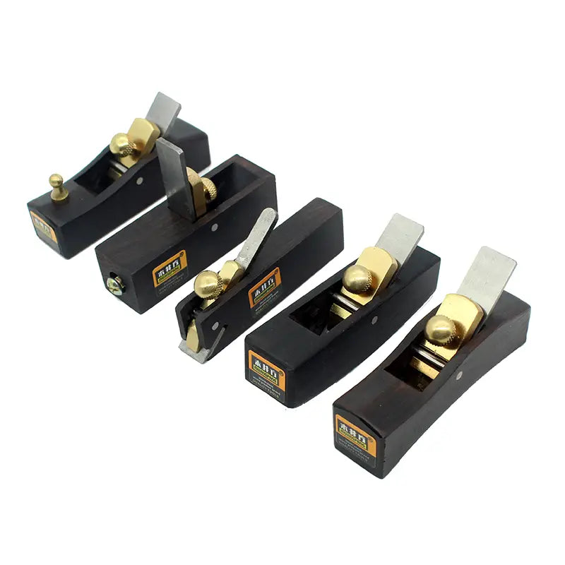 Set of five black ebony wood hand planes with brass knobs and silver blades for woodworking tasks.