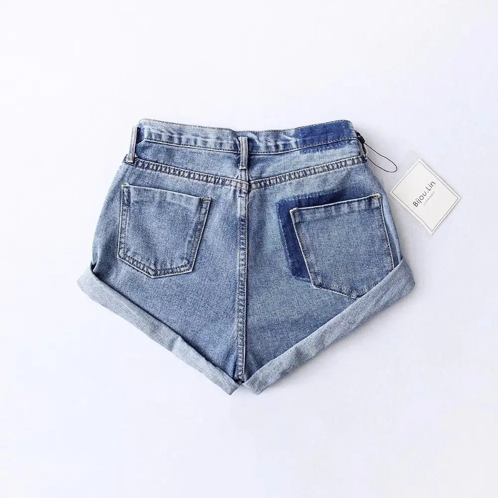 light-wash high waist denim shorts for women made of cotton featuring rolled cuffs and a contrasting dark blue patch on the right back pocket suitable for casual wear and available for delivery within business days.