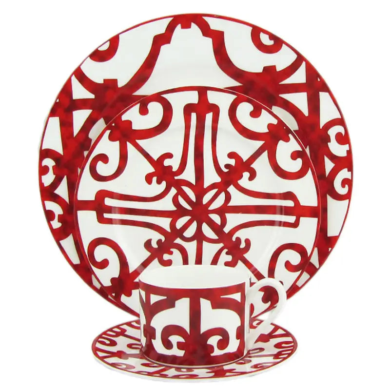 Bone china red scroll dinnerware set featuring red and white ornate ceramic plates with intricate scrollwork design.