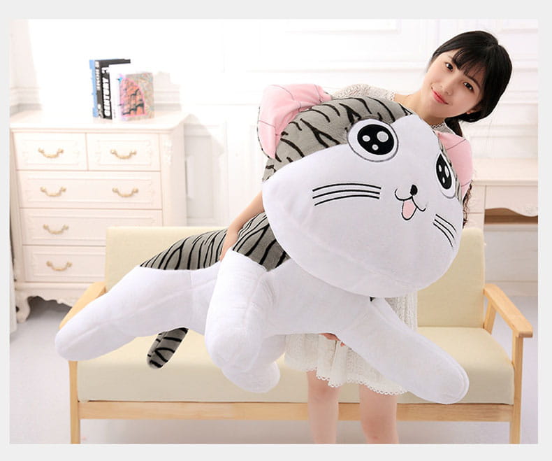 Cheese Cat soft animal plush toy featuring a plush oversized design with a white face and body, gray striped tail and legs, pink inner ears, black circular eyes with white pupils, and embroidered whiskers.