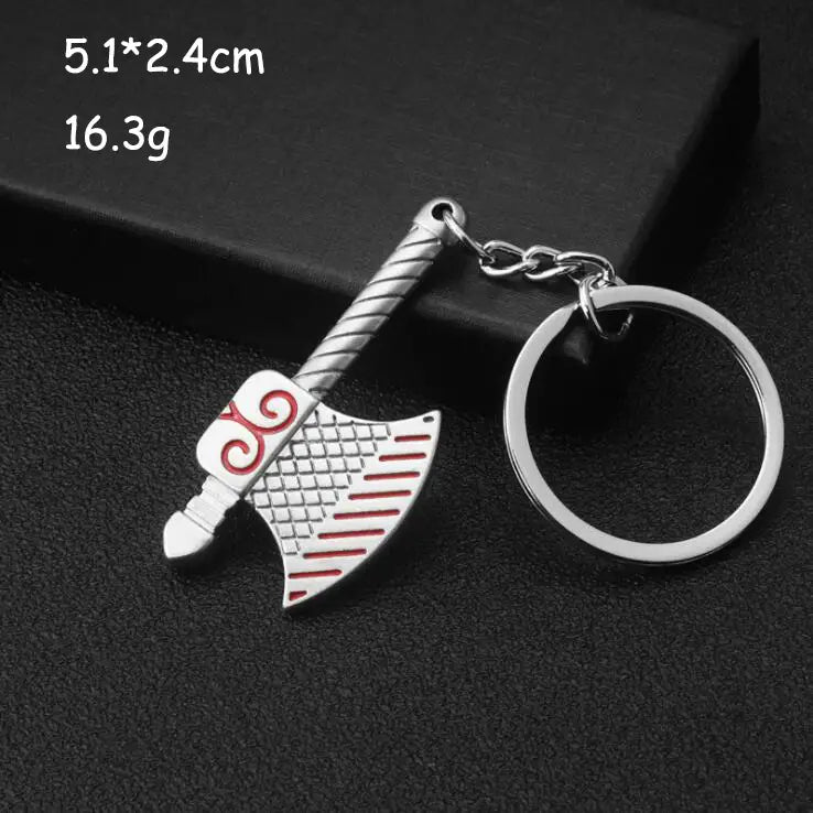 Silver-colored metal mini tool keychain shaped like an axe with red and white enamel detailing on the blade from a multi-tool key ring set.