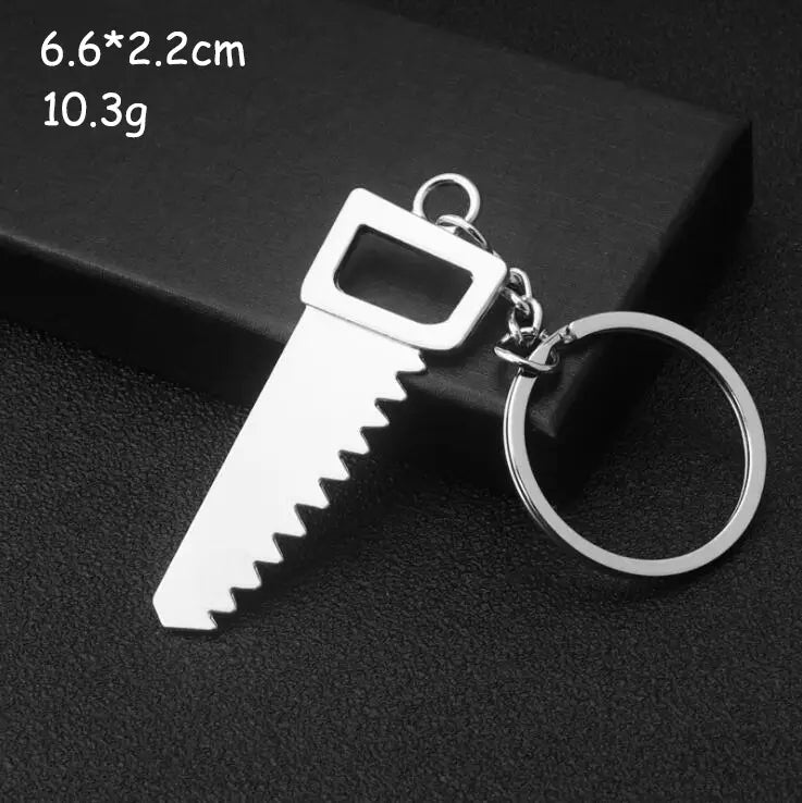 Silver-colored metal keychain shaped like a miniature saw with a rectangular handle and serrated blade from the mini tool keychain set metal multi-tool key ring.