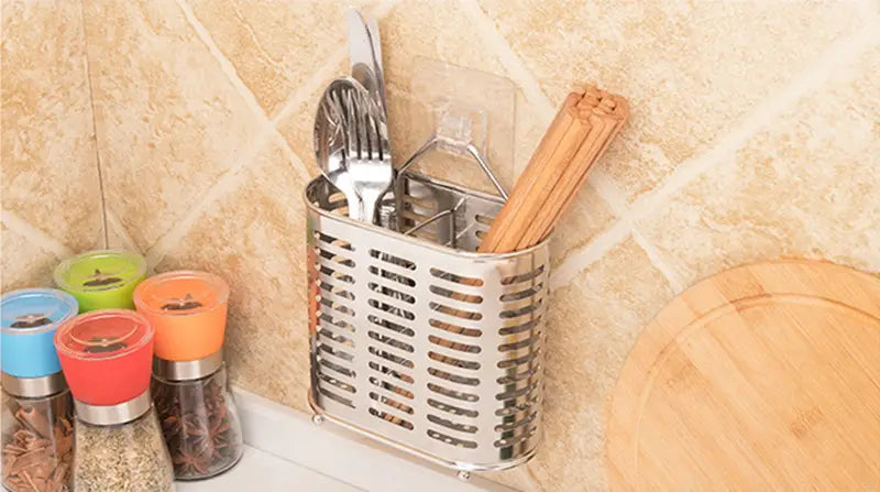 Stainless steel cutlery and utensil storage rack with a perforated wall-mounted design holding forks knives and chopsticks.