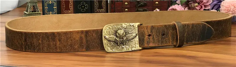 A vintage-style brown genuine leather belt with a detailed brass eagle buckle designed for men jeans.