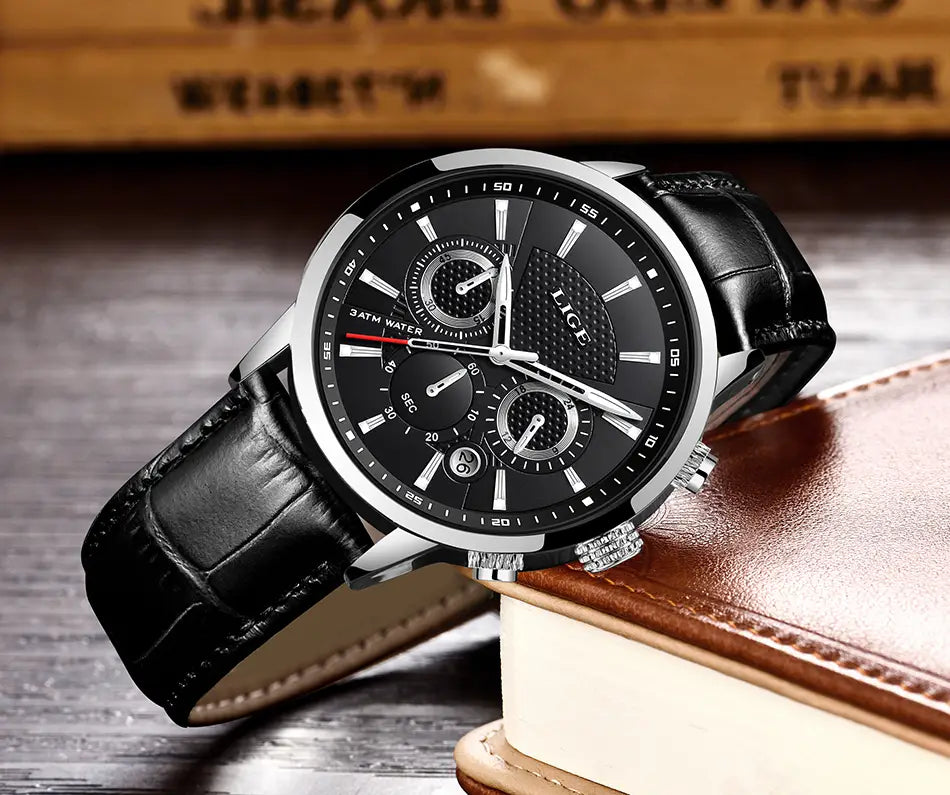 Lige men’s leather chronograph quartz watch with a black leather strap silver-toned case black dial three subdials white hour markers and brand name lice on the face.