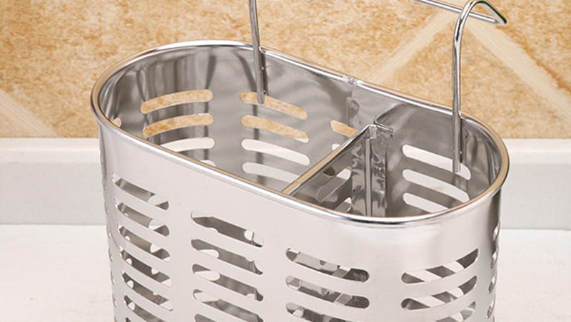 stainless steel cutlery and utensil storage rack featuring an oval perforated design and two curved hooks for hanging