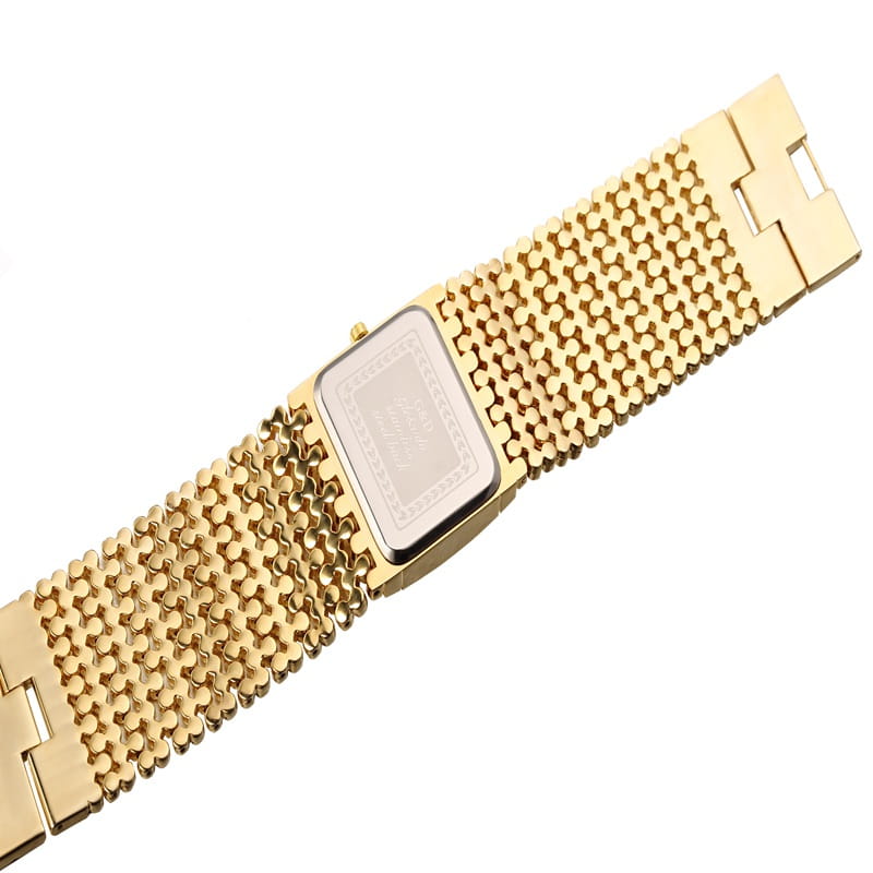 Gold quartz women watch with a rectangular crystal face and a gold mesh band featuring intricate engraved detailing.