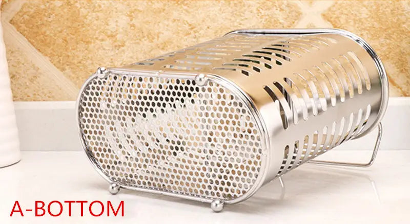 Stainless steel cutlery and utensil storage rack featuring a shiny cylindrical vegetable steamer design with perforations and small feet.