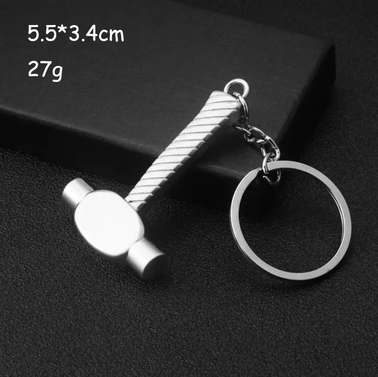 Silver metallic hammer-shaped keychain with textured ribbed handle and polished head from mini tool keychain set metal multi-tool key ring.